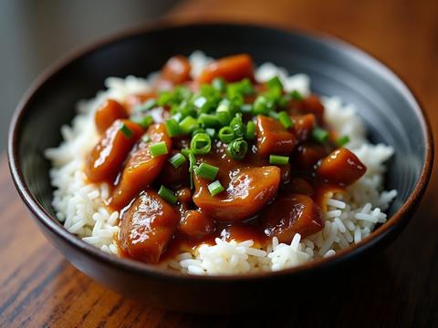 Chinese eggplant in a glossy red-brown garlic sauce with scallions
