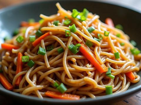 Vegetable lo mein — soft egg noodles tossed with carrots, cabbage and scallions in a glossy sauce